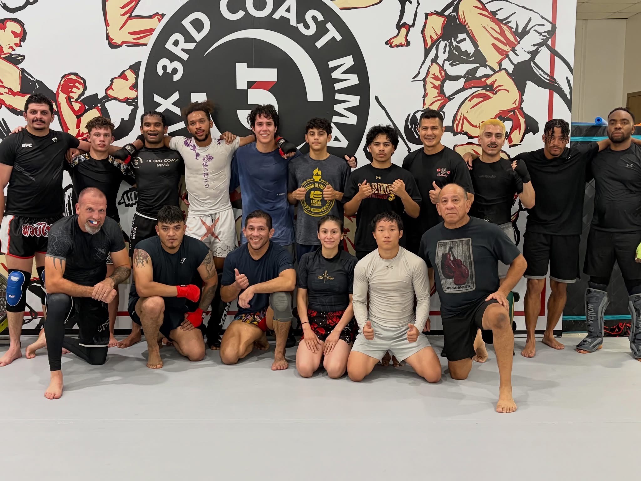 Martial arts students and coaches gathered as a team