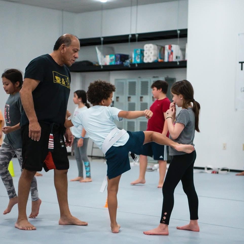 Youth martial arts class practicing together